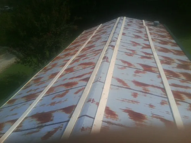 Rusted metal roof panels with new wood purlins before replacement — Storm Damage Roof Repair in Greenwood by Roofing Brothers